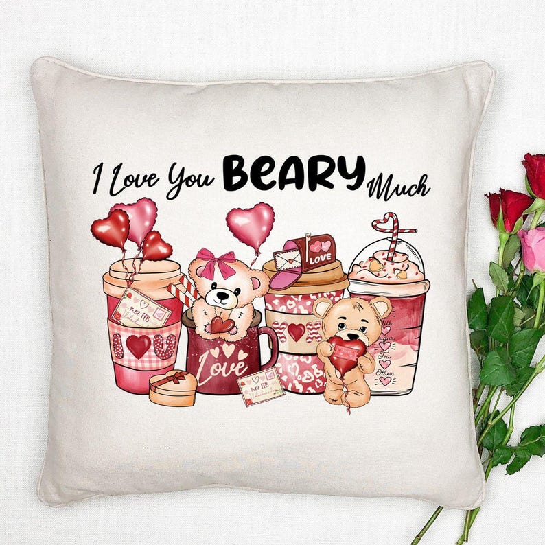 May include: A cream-colored throw pillow with a Valentine's Day design. The pillow features the phrase "I Love You Beary Much" above illustrations of teddy bears, hearts, and coffee cups. The design is in shades of red, pink, and brown.