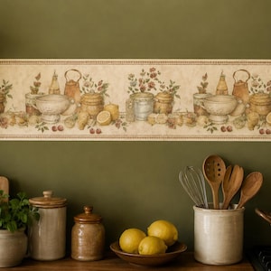 May include: A wallpaper border featuring a repeating pattern of kitchen still life elements including ceramic bowls, jars, teapots, lemons, and floral sprigs on a cream background with a decorative border edge at the top and bottom.