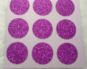 May include: A sheet of twelve pink glitter circle stickers. The stickers are arranged in three rows of four.