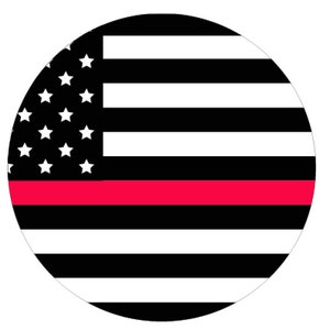 May include: Circular design featuring the American flag with a red stripe. The design includes white stars on a black background in the upper left quadrant, with black and white stripes and a red stripe across the center.