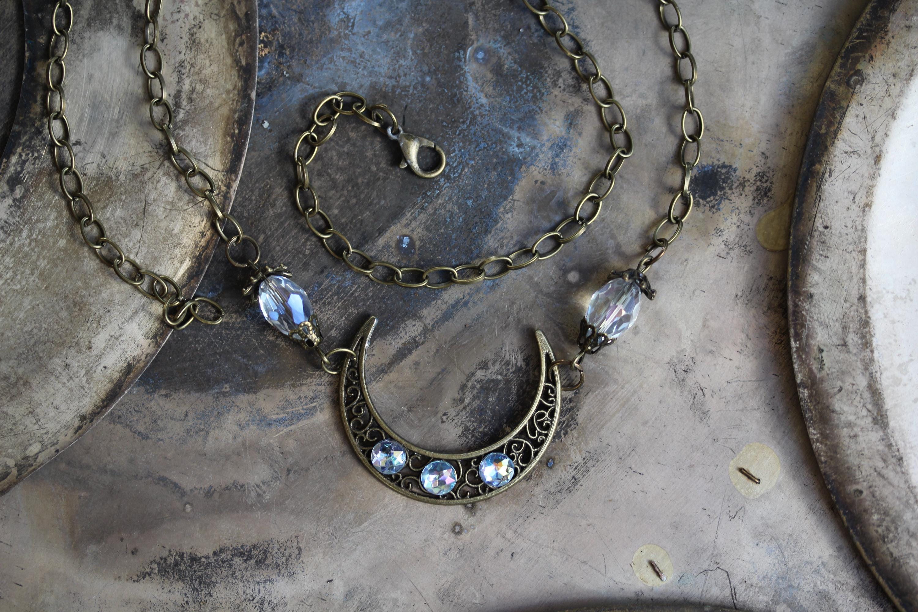 Crescent moon forehead ornament made of brass, glass beads and…