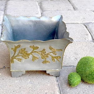 May include: A set of three ceramic mugs with a speckled, matte finish. The mugs are in shades of cream, light gray, and dark gray. Each mug has a simple, minimalist design, perfect for coffee or tea.