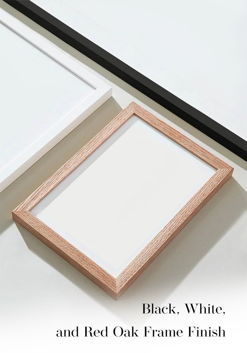 May include: Three picture frames in different finishes: black, white, and red oak. The frames are all empty and ready to be used.