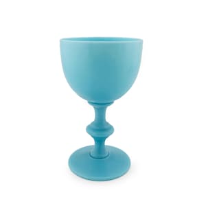 May include: A solid light blue goblet with a smooth, matte finish. The vessel features a wide, rounded bowl, a slender stem with a central decorative ring detail, and a circular base that provides stability for the upright standing structure.