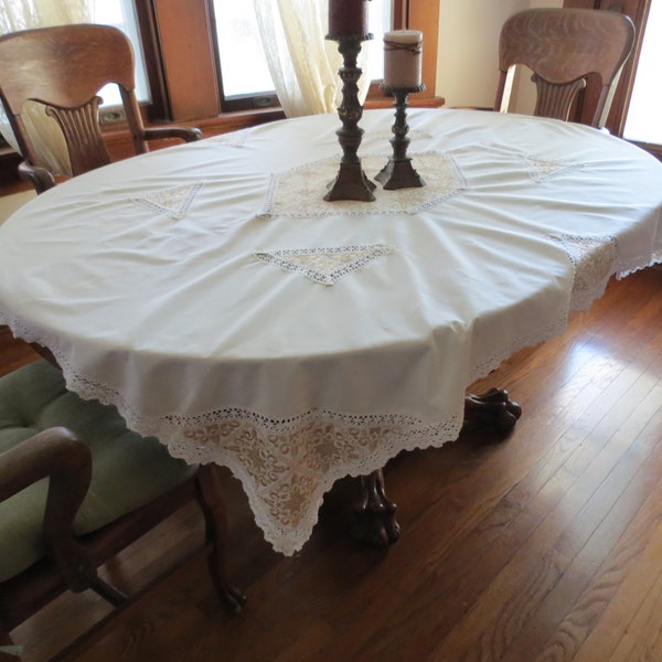 Regal vintage rectangle cream/ecru tablecloth with exquisite gold and cream broche.  Ideal for round, oval or square table