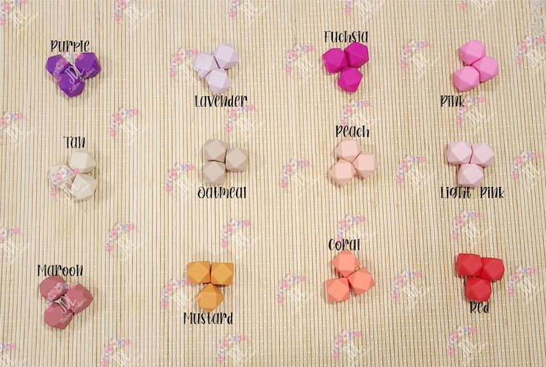 May include: A set of 12 silicone teethers in various colors, including purple, lavender, fuchsia, pink, light pink, tan, oatmeal, peach, coral, red, maroon, and mustard. The teethers are shaped like a geometric figure with multiple sides.