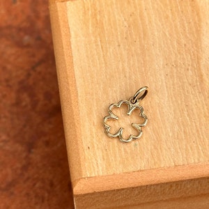 May include: A gold-colored four-leaf clover charm pendant.