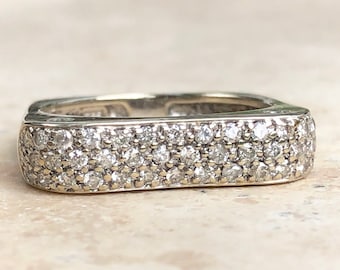 May include: A square-shaped band ring with a pave setting of small diamonds.