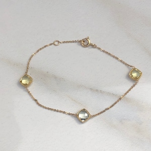 Armband i 14 karat gult guld med citronkvarts och grön ametistbesättning
