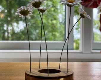 Crepe Paper Daisy set in wooden stand with brass engraved plaque reading ‘Little Golden-hearted Daisy’.