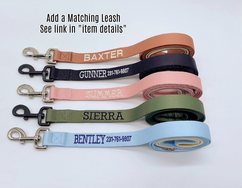 May include: Five personalized dog leashes in terracotta, navy, pink, olive green, and light blue. Each leash features a metal clasp and embroidered names including BAXTER, GUNNER 231-761-9807, SUMMER, SIERRA, and BENTLEY 231-761-9807. Text reads Add a Matching Leash See link in item details.