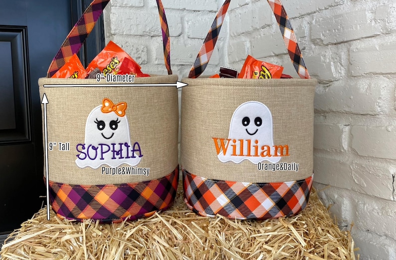 May include: Two personalized Halloween treat bags with ghost designs. The bags are 9 inches tall and 9 inches in diameter. One bag is decorated with purple and orange plaid and says "Sophia Purple&Whimsy". The other bag is decorated with orange and black plaid and says "William Orange&Daily".