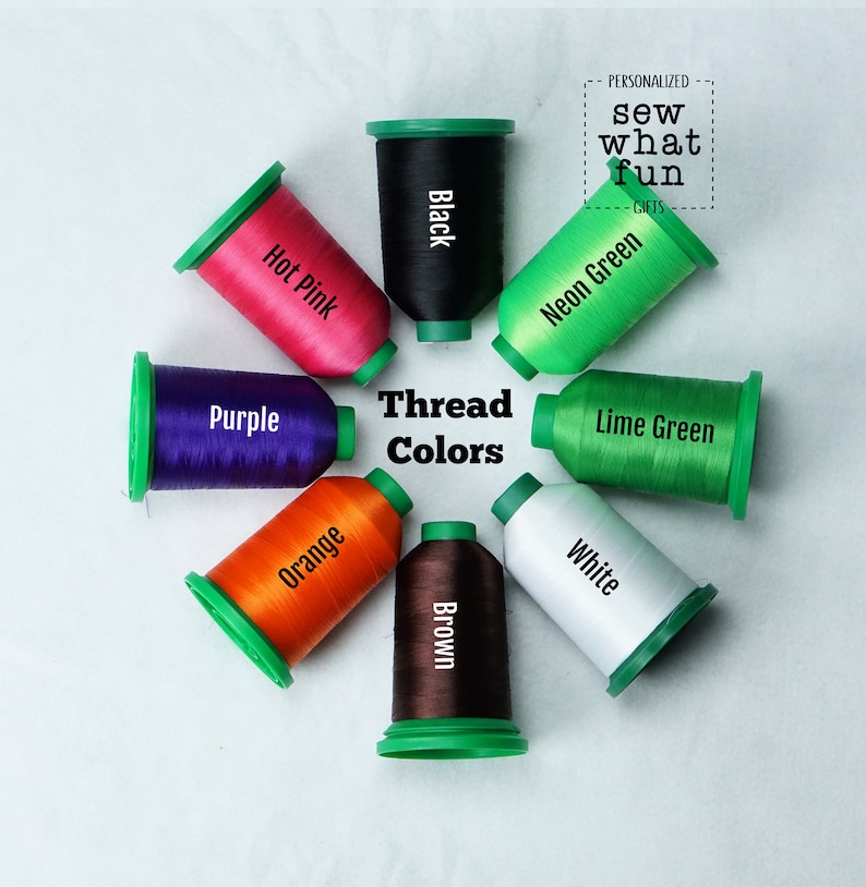 May include: A variety of thread spools in different colors, including hot pink, black, neon green, purple, orange, brown, lime green, and white. The spools are arranged in a circle with the words "Thread Colors" in the center.