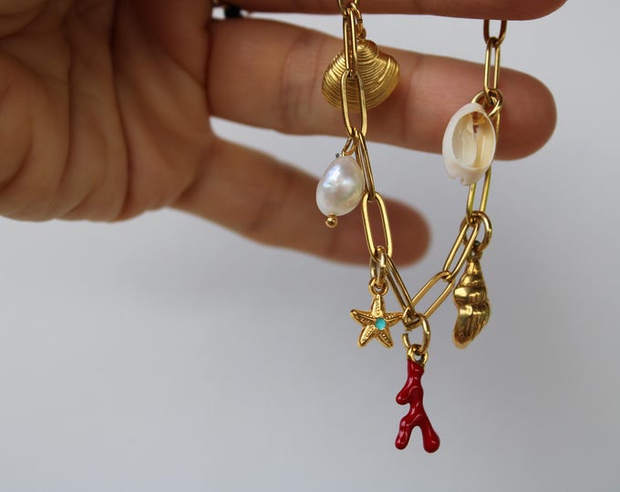 Multi charm bracelet. Paper clip bracelet with stainless steel charms and pearl. Gold