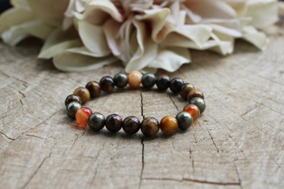 Bracelet for abundance and protection.  Unisex beaded stretch bracelet. Carnelian, pyrite, tiger's eye, bronzite. 8mm gemstones.