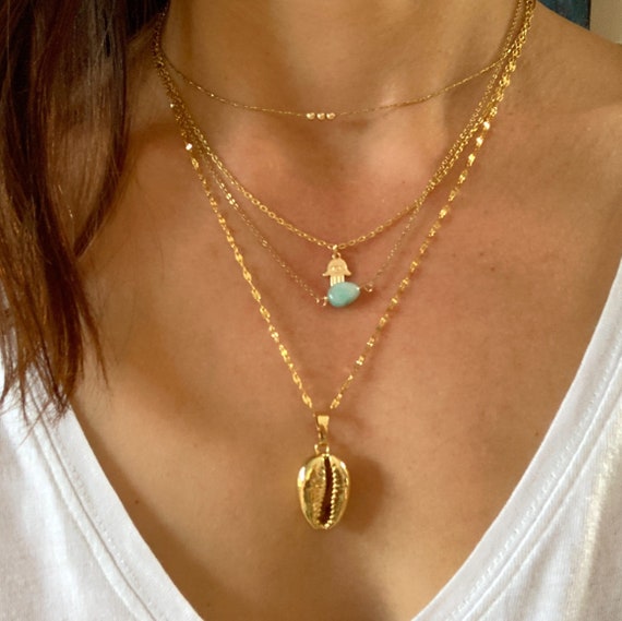 Gold cowrie shell necklace.Shell necklace. Gold dipped cowrie shell necklace. Layering necklace. Stainless steel chain.