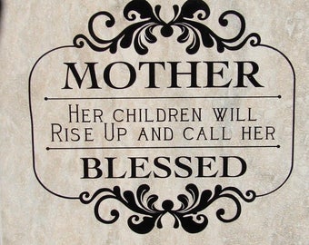 May include: A beige tile with black lettering that reads "MOTHER, HER CHILDREN WILL RISE UP AND CALL HER BLESSED, PROVERBS 31". The text is surrounded by a decorative black floral design.