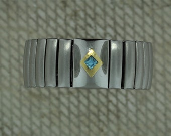 Stainless Steel Stretch Band with Light Blue Princess Cut in 18kt Yellow Gold Bezel