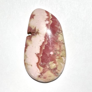 May include: A pink and white cabochon gemstone with a swirling pattern. The stone is smooth and polished, with a teardrop shape.