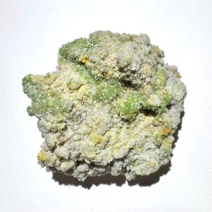 May include: A raw mineral specimen featuring a cluster of crystalline formations with a textured surface. The stone displays a mix of pale off-white, light yellow, and vibrant lime green hues, with small needle-like crystal structures visible throughout.