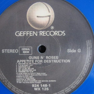 May include: A black vinyl record with a blue label. The label has the text "Geffen Records", "Guns N' Roses", "Appetite for Destruction", "Stereo", "Side G", "924 148-1", and "WX 125".