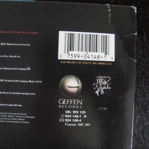 May include: Black and white record album cover with the band name "Uzi Suicide" in a stylised font. The album is by Geffen Records and has the barcode 0 7599-24148-1 4. The album is also available on cassette and compact disc.