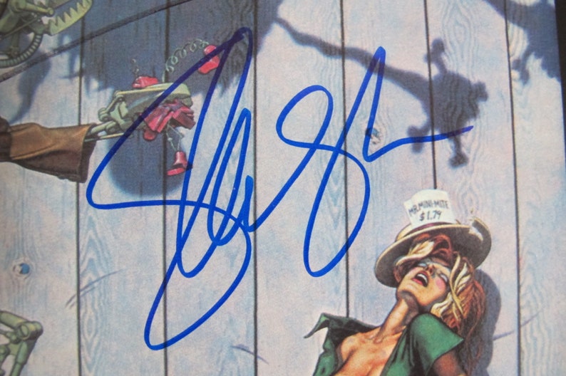 May include: A blue signature on a white background. The signature is for "Jeff Beck".