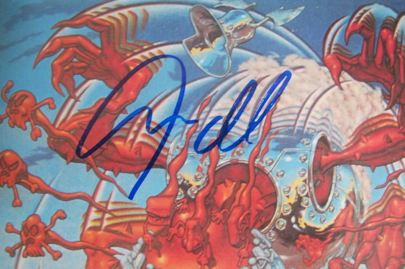 May include: A blue and white album cover with a signature in blue ink that says "Gall". The cover features a red and silver robot with multiple arms.