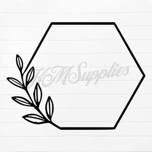 May include: Black hexagon frame with a leafy branch on a white wood-grain background. The frame has a clean, modern design, perfect for crafting or design projects. The image includes the text "KM Supplies" in a light gray color.