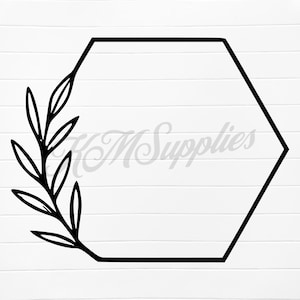 May include: Black hexagonal frame with a leafy branch on a white background. The frame is empty, and the branch is on the left side. The text "KM Supplies" is faintly visible in the background.