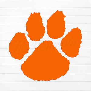 May include: Orange paw print with five toes. The paw print is a common symbol for loyalty and friendship.