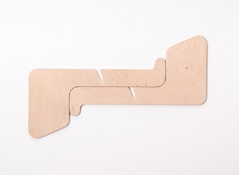 May include: A light brown wooden stand with two interlocking pieces. The stand is designed to hold a laptop or tablet.