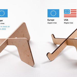 May include: Two wooden laptop stands, one made from birch and one from maple. The birch stand is labeled "Europe" and the maple stand is labeled "USA".