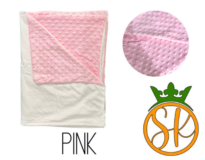 May include: Pink and white weighted blanket with a soft, textured surface. The blanket is folded in half and has a white backing.