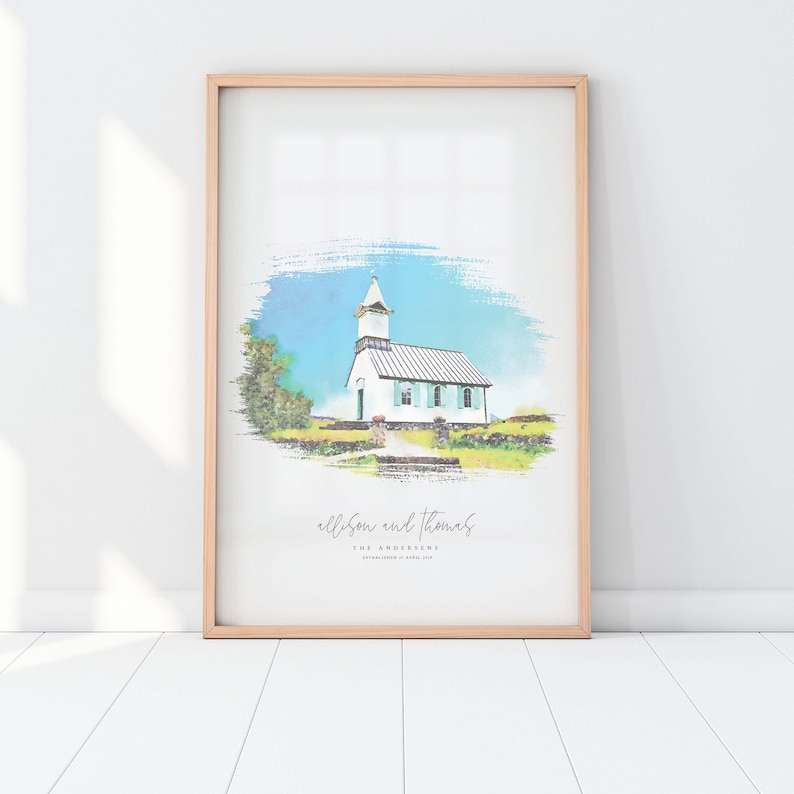 May include: A watercolor painting of a white church with a green roof and a steeple. The church is surrounded by green grass and trees. The painting is framed in a light wood frame. The text "Allison and Thomas" is written below the church.