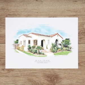 May include: A watercolor illustration of a white house with a red tile roof. The house has a front porch with a wooden door and a walkway leading to the front door. The house is surrounded by green plants and trees. The text "35&deg; 27' N | 112&deg; 29' W" and "CALIFORNIA DREAMS" is below the house.