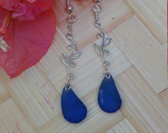Seaglass earrings of cobalt blue hung from sterling silver vine