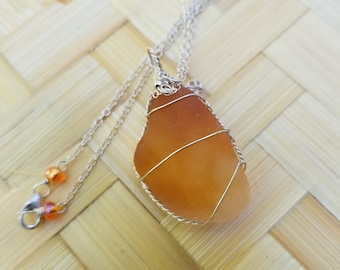 Fantastic orange flashglass pendant wrapped in sterling silver wire hung from sterling silver chain