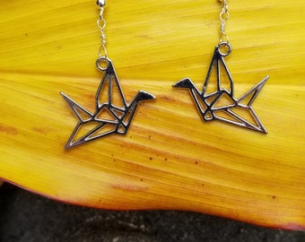 Silver origami crane earrings hung from sterling silver wire