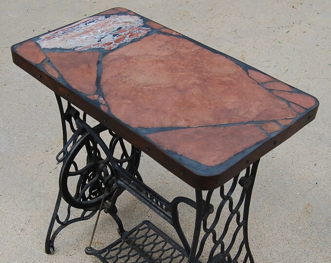 Singer 166: A natural stone topped table featuring a sewing machine base and a pretty rock with an ugly name
