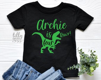May include: Black t-shirt with a green dinosaur graphic and the text "Archie is four Rawr!"