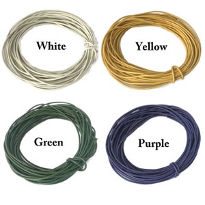 May include: Four spools of leather cord in different colors: white, yellow, green, and purple.