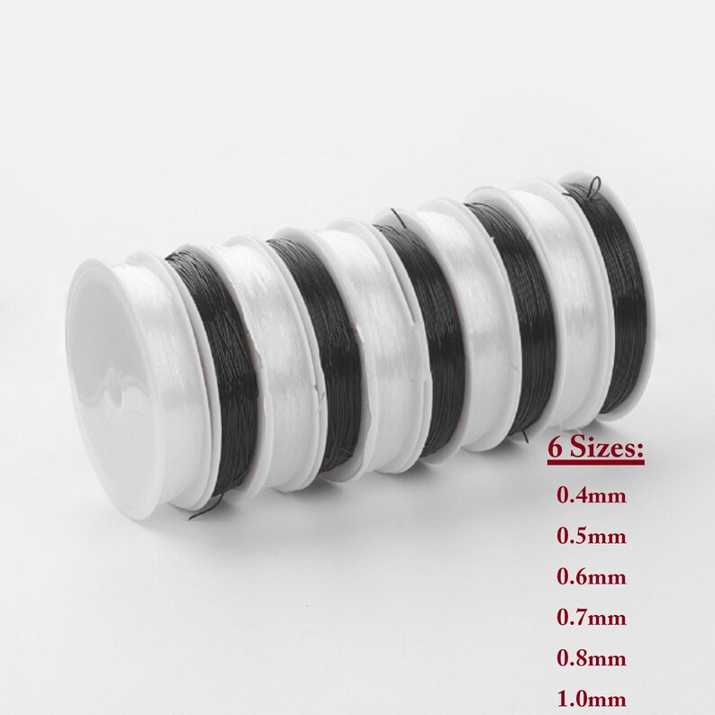May include: Six spools of black elastic cord in various sizes, ranging from 0.4mm to 1.0mm. The spools are white and arranged in a stack.
