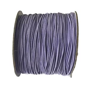 May include: A spool of lavender-colored elastic cord. The cord is wound tightly around a cardboard spool.