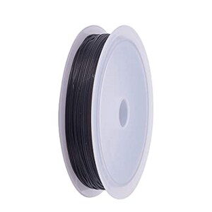 May include: A spool of black jewelry wire, wound around a white plastic bobbin.