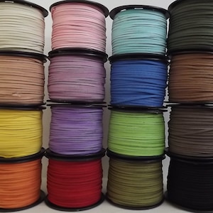 May include: A collection of 12 spools of leather cord in various colours, including beige, pink, light blue, dark green, brown, yellow, purple, green, orange, red, olive green, and black.