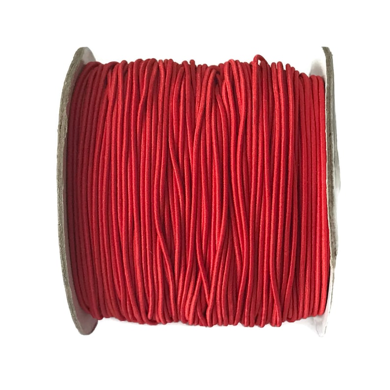 May include: A spool of red elastic cord, perfect for crafting projects.