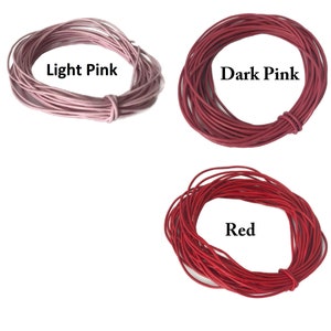 May include: Three spools of leather cord in different shades of pink and red. The spools are labeled "Light Pink", "Dark Pink", and "Red".