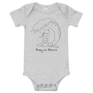 May include: A grey baby grow with a black line drawing of a baby wearing sunglasses and surfing on a wave. The text "Baby on Board" is written below the image.