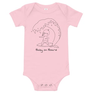 May include: Pink baby grow with a black line drawing of a baby wearing sunglasses and riding a surfboard on a wave. The text "Baby on Board" is printed below the image.
